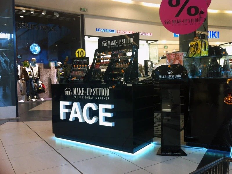 Makeup Studio illuminated retail kiosk signage