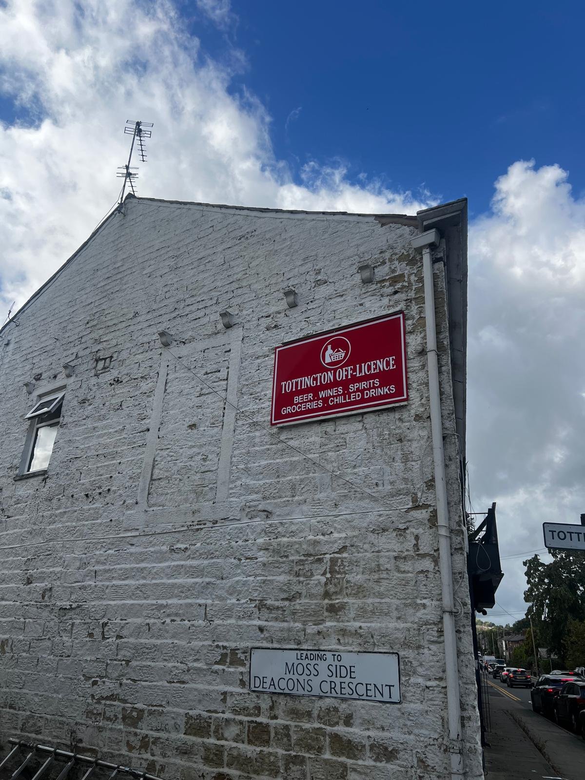 Tottington Off Licence wall signboard